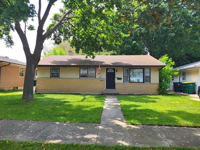 2110 Gilead Ave, Zion, IL 60099 - view of front of house with brick siding, a front lawn, and a chimney