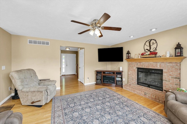 3911 Tallgrass Dr, Champaign, IL 61822 - living area featuring a brick fireplace, a ceiling fan, and wood finished floors