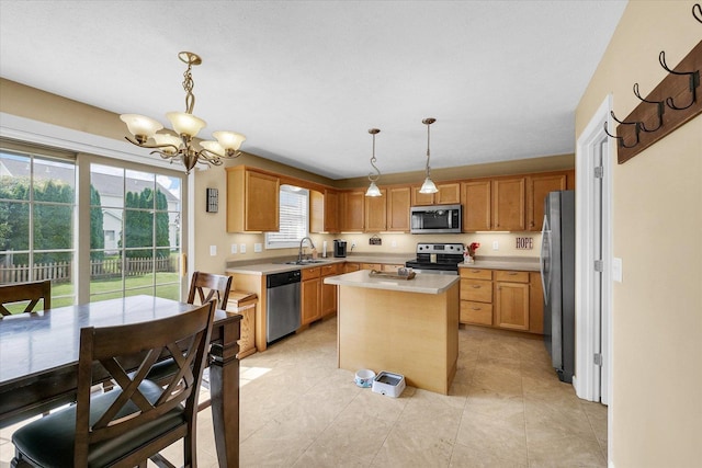 3911 Tallgrass Dr, Champaign, IL 61822 - kitchen with appliances with stainless steel finishes, a chandelier, light countertops, a center island, and decorative light fixtures