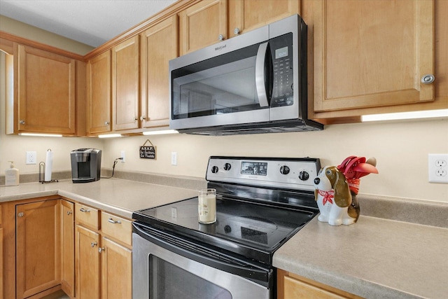 3911 Tallgrass Dr, Champaign, IL 61822 - kitchen with appliances with stainless steel finishes and light countertops