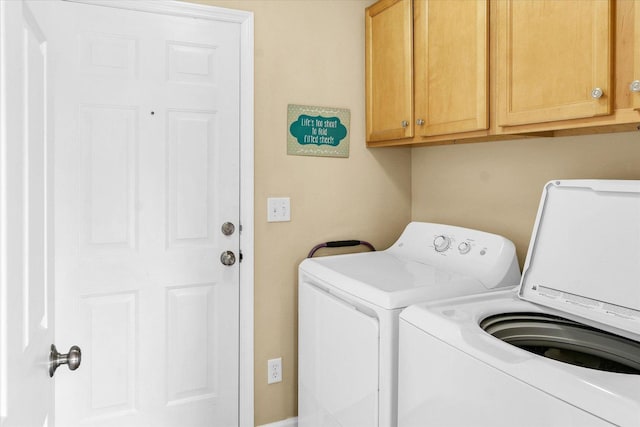 3911 Tallgrass Dr, Champaign, IL 61822 - laundry area featuring washer and dryer and cabinet space