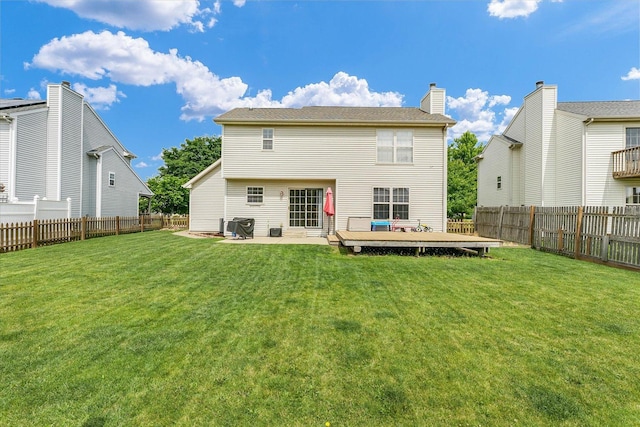 3911 Tallgrass Dr, Champaign, IL 61822 - back of house with a fenced backyard, a deck, and a chimney