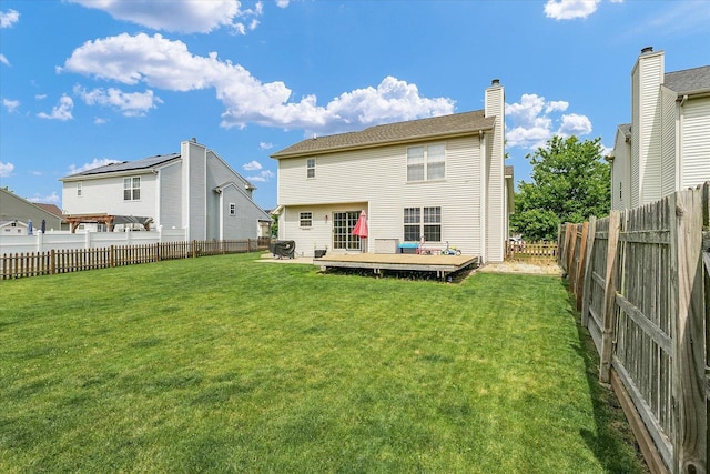 3911 Tallgrass Dr, Champaign, IL 61822 - rear view of property with a deck, a fenced backyard, and a chimney