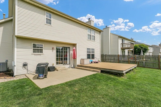 3911 Tallgrass Dr, Champaign, IL 61822 - back of house with a fenced backyard, a wooden deck, a chimney, and a patio