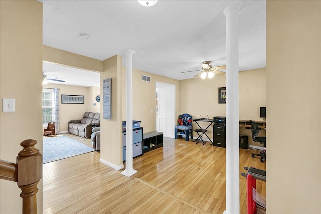 3911 Tallgrass Dr, Champaign, IL 61822 - exercise room featuring ornate columns, a ceiling fan, and light wood-type flooring