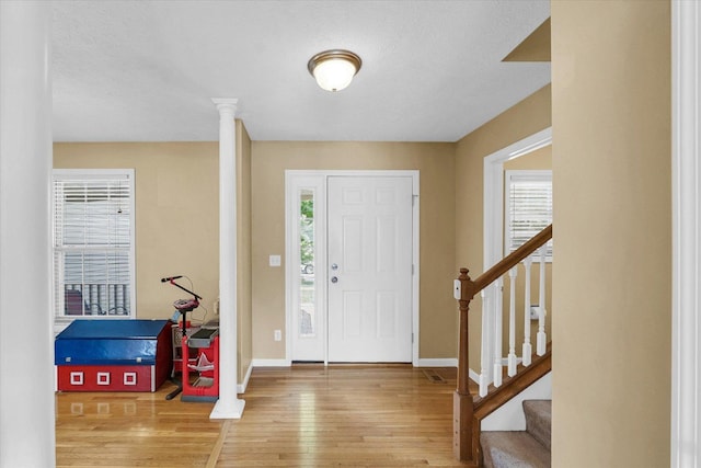 3911 Tallgrass Dr, Champaign, IL 61822 - foyer featuring wood-type flooring, plenty of natural light, stairs, and a textured ceiling