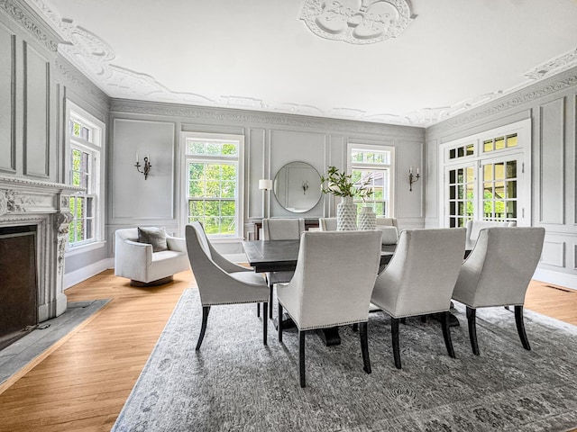 141 Loretto Ct, Wheaton, IL 60189 - dining room with a decorative wall, healthy amount of natural light, light wood finished floors, a chandelier, and a fireplace