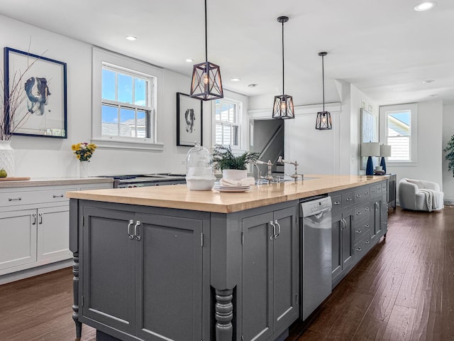 141 Loretto Ct, Wheaton, IL 60189 - kitchen with butcher block counters, stainless steel dishwasher, healthy amount of natural light, an island with sink, and recessed lighting