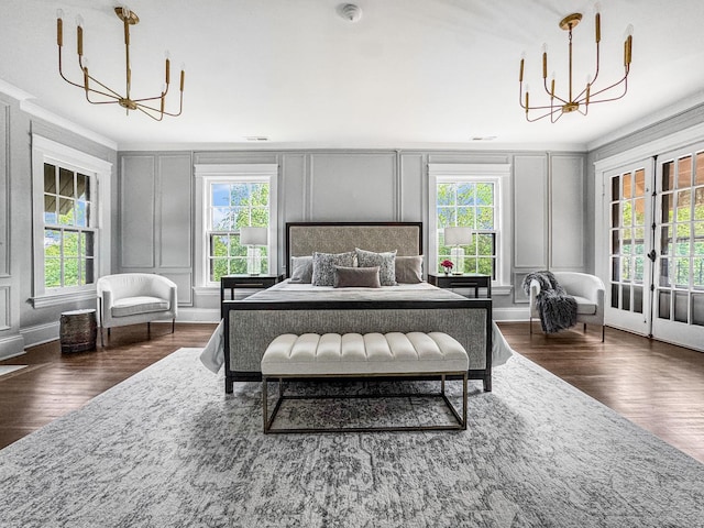 141 Loretto Ct, Wheaton, IL 60189 - bedroom featuring a chandelier, a decorative wall, dark wood-style flooring, ornamental molding, and french doors