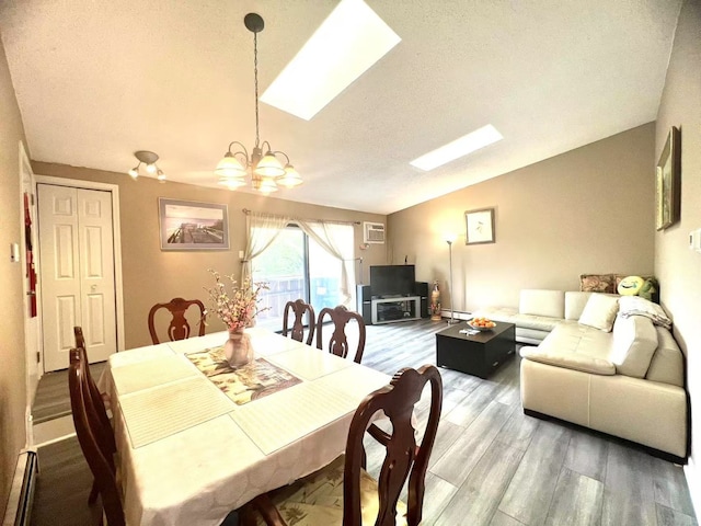 11 Echo Ct Unit 17, Vernon Hills, IL 60061 - dining space with a chandelier, vaulted ceiling, light wood-type flooring, a wall unit AC, and a baseboard radiator
