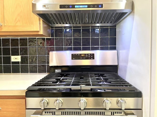 11 Echo Ct Unit 17, Vernon Hills, IL 60061 - kitchen view of gas range, ventilation hood, light countertops, and decorative backsplash