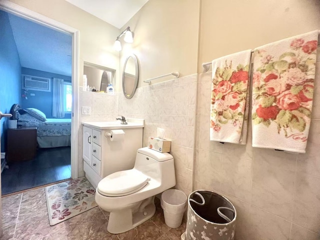 11 Echo Ct Unit 17, Vernon Hills, IL 60061 - ensuite bathroom featuring tile walls, vanity, a wainscoted wall, and an AC wall unit