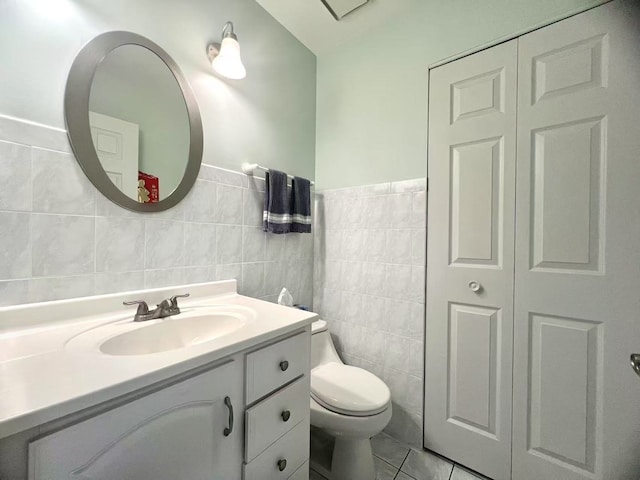 11 Echo Ct Unit 17, Vernon Hills, IL 60061 - half bathroom featuring vanity, tile walls, tile patterned flooring, and wainscoting