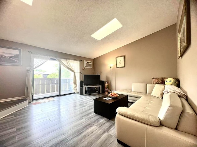 11 Echo Ct Unit 17, Vernon Hills, IL 60061 - living area with lofted ceiling, a textured ceiling, light wood finished floors, and a wall mounted air conditioner