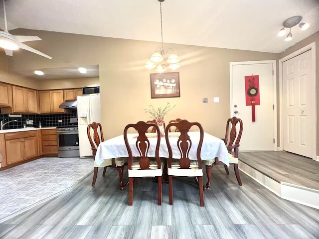 11 Echo Ct Unit 17, Vernon Hills, IL 60061 - dining area with light wood finished floors, vaulted ceiling, a chandelier, and a ceiling fan