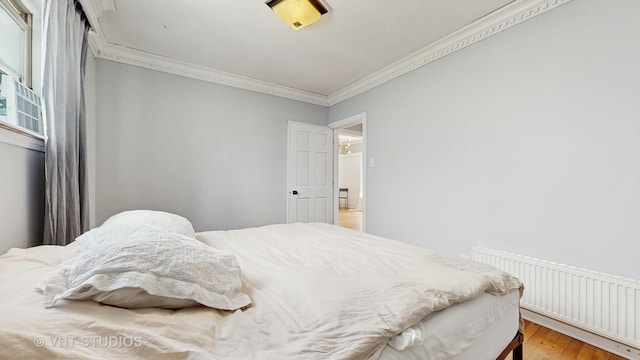 117 S Grove Ave, Oak Park, IL 60302 - bedroom featuring radiator heating unit, crown molding, and light wood finished floors