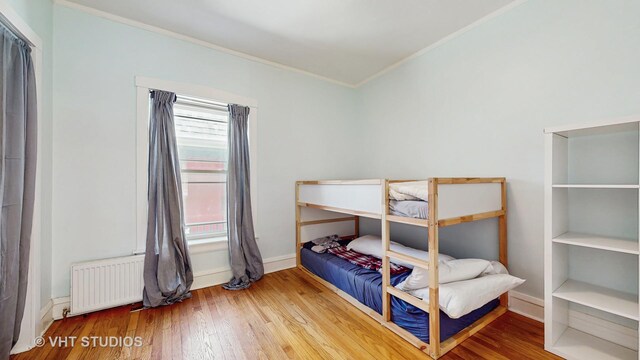117 S Grove Ave, Oak Park, IL 60302 - bedroom with radiator, ornamental molding, and wood finished floors