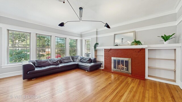 117 S Grove Ave, Oak Park, IL 60302 - living area with light wood-type flooring, healthy amount of natural light, a fireplace, and ornamental molding