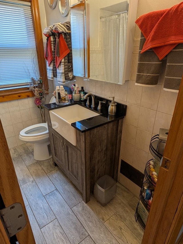 bathroom featuring tile walls and vanity