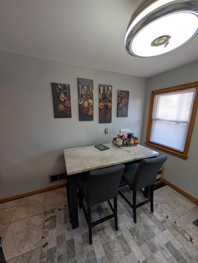 dining space featuring baseboards