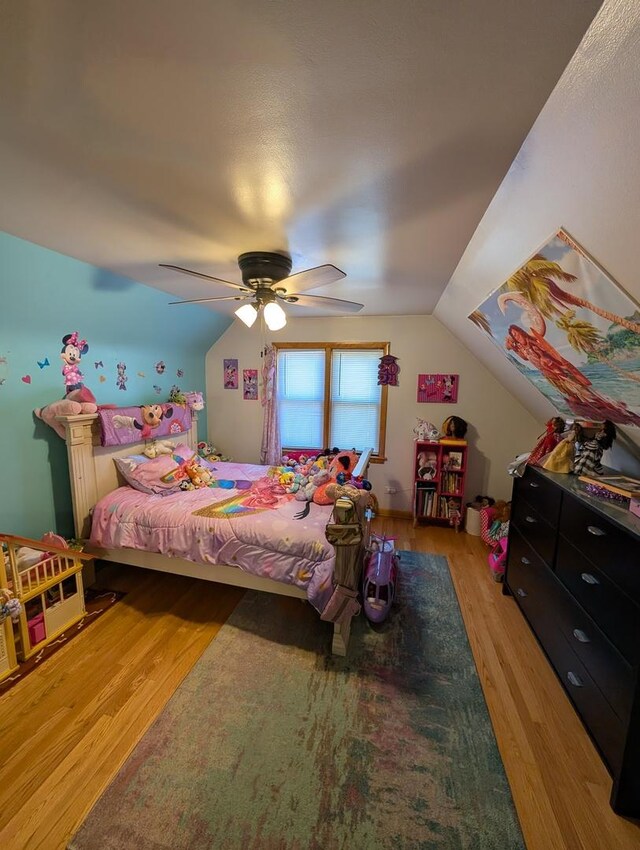 bedroom with light wood finished floors, lofted ceiling, and ceiling fan
