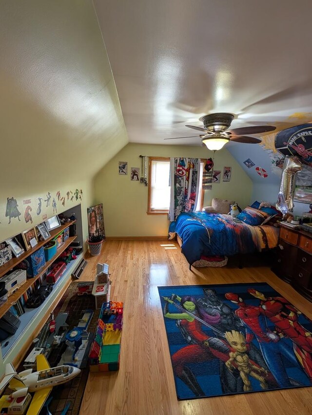 bedroom with vaulted ceiling, wood finished floors, and a ceiling fan