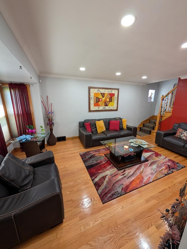 living room with stairs, recessed lighting, and wood finished floors