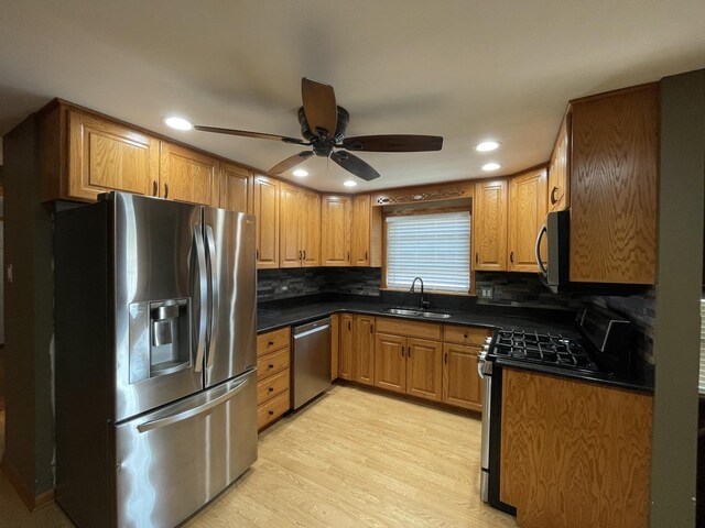10505 S Central Park Ave, Chicago, IL 60655 - kitchen featuring appliances with stainless steel finishes, dark countertops, ceiling fan, decorative backsplash, and light wood-style flooring