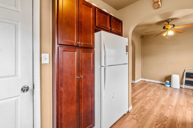 3914 Madison St, Bellwood, IL 60104 - kitchen with freestanding refrigerator, arched walkways, light wood finished floors, and a ceiling fan
