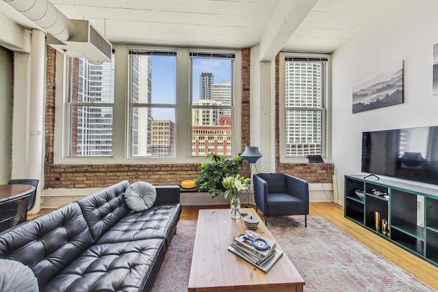 124 W Polk St Unit 603, Chicago, IL 60605 - living room featuring brick wall and wood finished floors