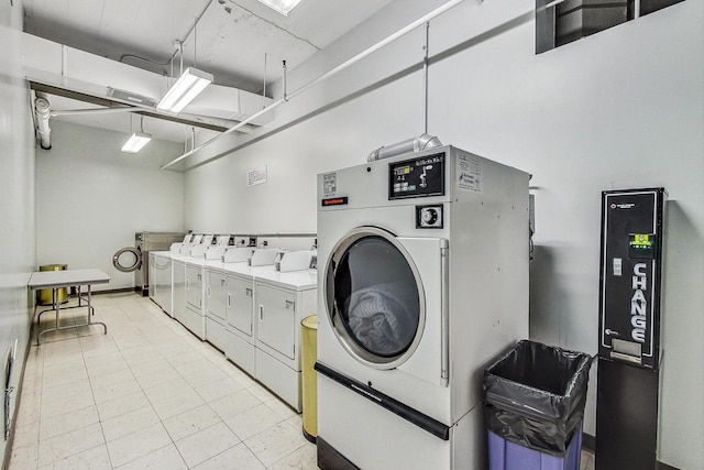 124 W Polk St Unit 603, Chicago, IL 60605 - shared laundry featuring washing machine and dryer and light tile patterned floors