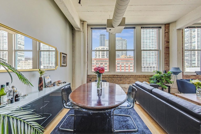 124 W Polk St Unit 603, Chicago, IL 60605 - dining space with light wood finished floors, a city view, and brick wall