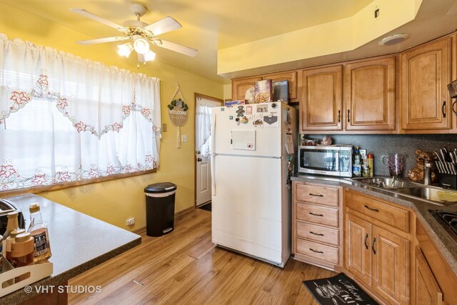 1550 Marshall Dr, Des Plaines, IL 60018 - kitchen featuring freestanding refrigerator, stainless steel microwave, light wood finished floors, ceiling fan, and brown cabinetry