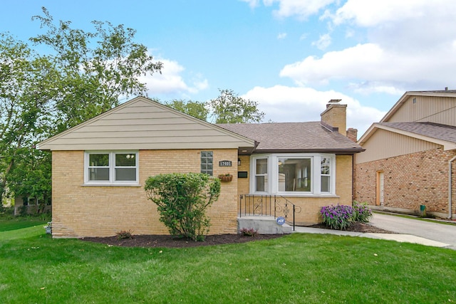 17401 Emerson Ave, Hazel Crest, IL 60429 - view of front of house featuring brick siding, a front lawn, a chimney, and roof with shingles