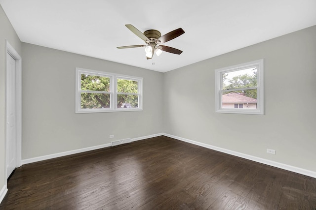 17401 Emerson Ave, Hazel Crest, IL 60429 - unfurnished bedroom with multiple windows, dark wood-style flooring, and a ceiling fan