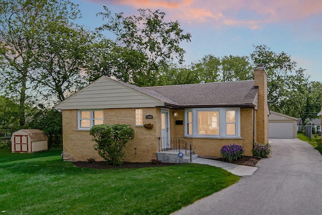 17401 Emerson Ave, Hazel Crest, IL 60429 - bungalow-style home featuring a garage, a chimney, a lawn, brick siding, and a shingled roof