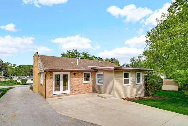 17401 Emerson Ave, Hazel Crest, IL 60429 - rear view of house with french doors, a chimney, driveway, and brick siding