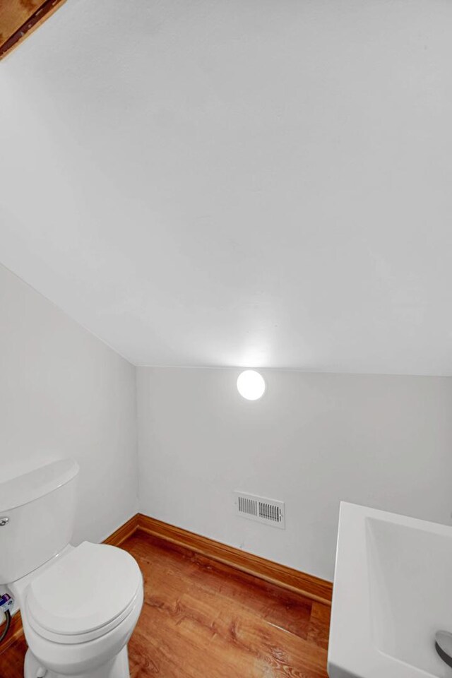 1515 E 85th St, Chicago, IL 60619 - bathroom featuring wood finished floors and lofted ceiling