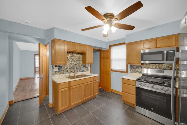 1515 E 85th St, Chicago, IL 60619 - kitchen with stainless steel appliances, ceiling fan, light countertops, tasteful backsplash, and dark tile patterned floors
