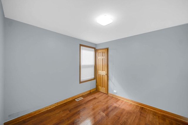 1515 E 85th St, Chicago, IL 60619 - spare room with baseboards and wood finished floors