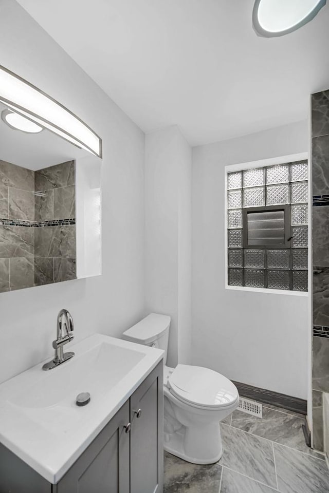 1515 E 85th St, Chicago, IL 60619 - bathroom featuring marble look tiles, vanity, and tiled shower