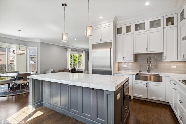 1780 Prairie Ave, Northbrook, IL 60062 - kitchen featuring stainless steel built in fridge, a kitchen island, ornamental molding, white cabinets, and dark wood-type flooring