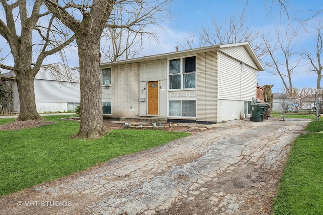 350 E Tulip Dr, Glenwood, IL 60425 - split foyer home featuring asphalt driveway, brick siding, and a gate