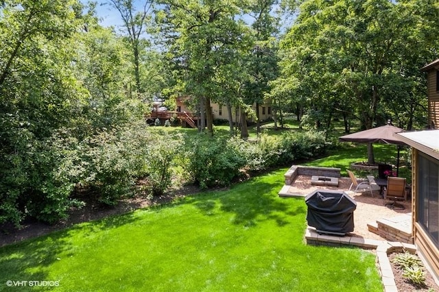 401 Woodside Dr, Wood Dale, IL 60191 - view of grassy yard featuring a fire pit and a patio