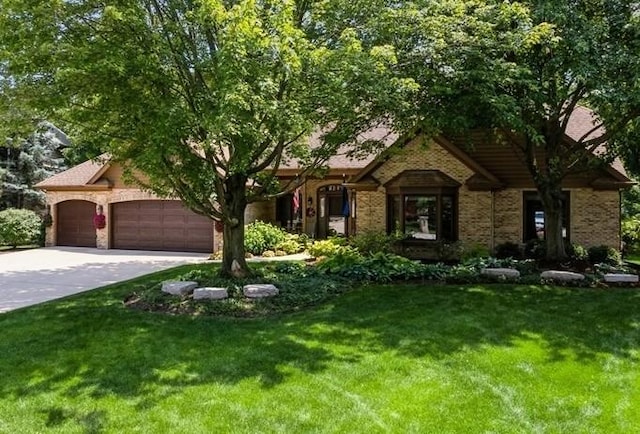 401 Woodside Dr, Wood Dale, IL 60191 - view of front of house with a front yard, an attached garage, driveway, and brick siding