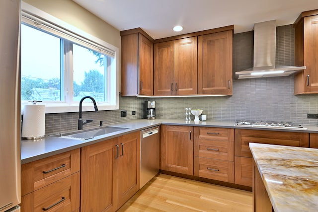 717 S Washington St, Elmhurst, IL 60126 - kitchen with wall chimney range hood, light wood finished floors, appliances with stainless steel finishes, brown cabinets, and tasteful backsplash