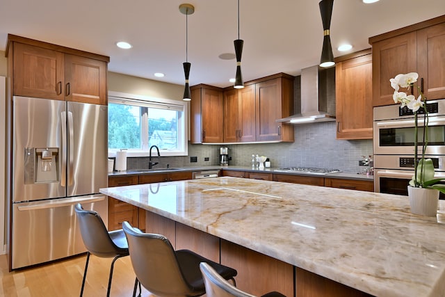 717 S Washington St, Elmhurst, IL 60126 - kitchen with stainless steel appliances, wall chimney range hood, light stone countertops, a kitchen breakfast bar, and tasteful backsplash