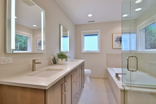 717 S Washington St, Elmhurst, IL 60126 - bathroom with healthy amount of natural light, double vanity, a bath, tile patterned floors, and recessed lighting