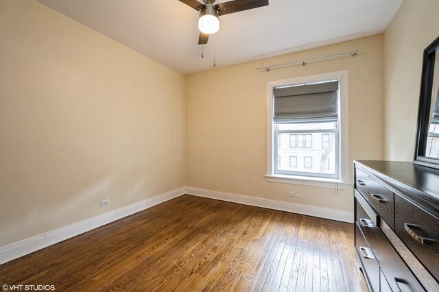 6970 N Wolcott Ave Unit 1, Chicago, IL 60626 - unfurnished bedroom with dark wood-type flooring and a ceiling fan
