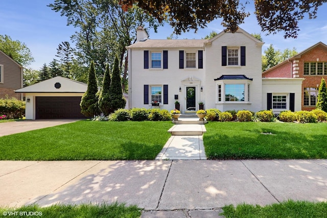 4335 Lee St, Skokie, IL 60076 - colonial house with a chimney, a garage, and a front lawn